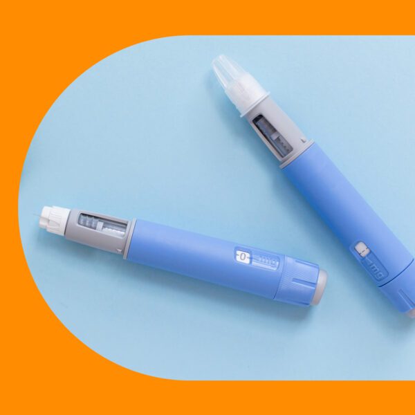 Two blue insulin pens with dosage indicators