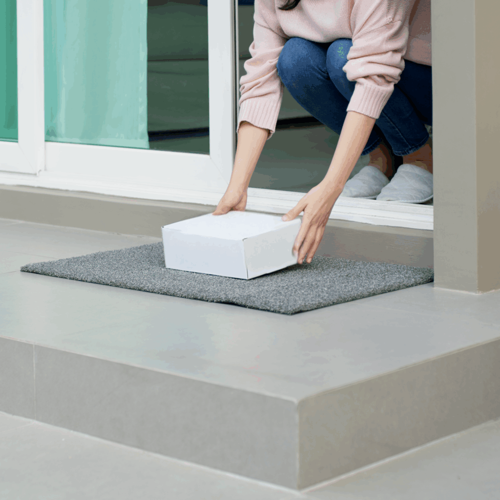 a girl with a box sitting at the outdoor