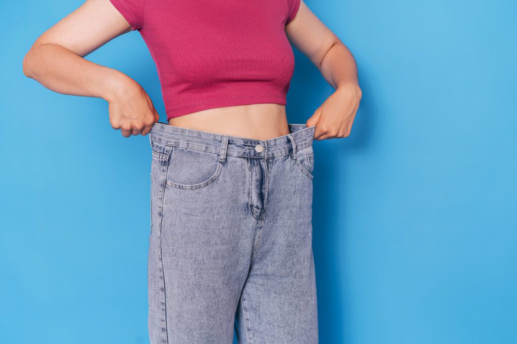 a girl who is loosing the weight and Try the jeans fitting